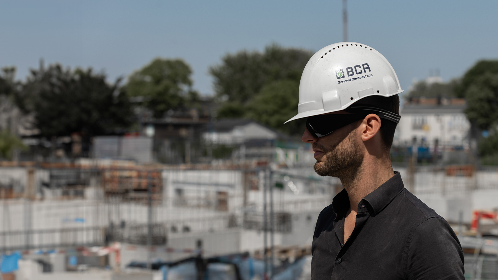 BCA is committed to safety. Photo of worker on a jobsite wearing a hardhat with a BCA sticker.